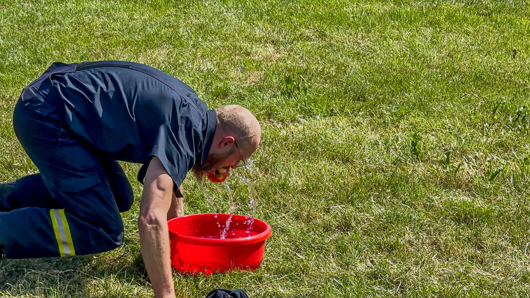 Spassspiel: Apfelbeissen, es muss ein Apfel aus einem Behälter mit Wasser gefischt werden. Dabei darf nur der Mund genutzt werden.